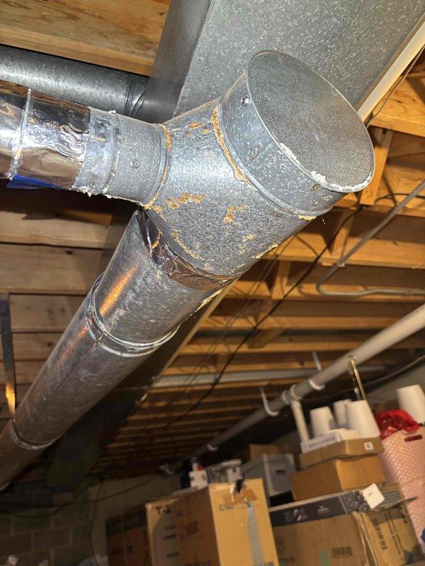 Completed comprehensive BFMA tune-up service on 12-year-old furnace system, including full inspection, cleaning, and performance testing of all components. Identified and documented safety concern with water heater exhaust pipe requiring correction to meet code compliance. Observed significant condensation accumulation on supply ductwork in basement mechanical space, indicating potential insulation deficiency or humidity imbalance that may require future attention to prevent moisture-related issues.
