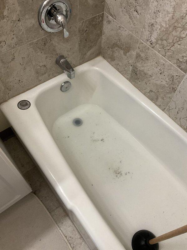 # Plumbing Service Completed

Responded to service call for clogged drain and backup issue in residential bathroom. Upon arrival, inspected both shower and bathtub fixtures to identify source of drainage problem. Assessed the walk-in shower with mosaic tile floor and center drain, as well as the adjacent bathtub with built-in drain and overflow system. Utilized appropriate drain clearing tools and techniques to remove obstruction from the affected drain line. Successfully restored proper water flow and drainage function to both fixtures. Tested system to verify complete resolution of backup issue and confirmed all drains operating normally.