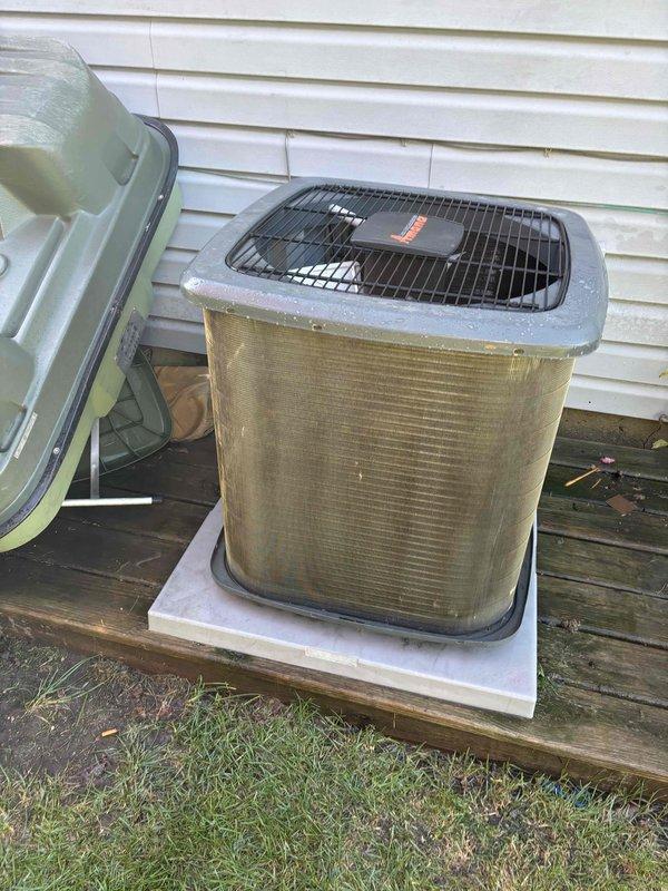 Completed comprehensive air conditioning tune-up on 5-year-old Bryant condenser unit. Upon arrival, observed significant accumulation of dirt, debris, and environmental contamination on exterior coil fins, appearing as yellowish-green and brownish discoloration that could restrict airflow and reduce system efficiency. Performed standard maintenance protocol including coil cleaning, refrigerant level verification, electrical connection inspection, and fan motor operation assessment. Additionally completed dryer vent cleaning service as requested. Unit operational and cooling properly upon service completion.