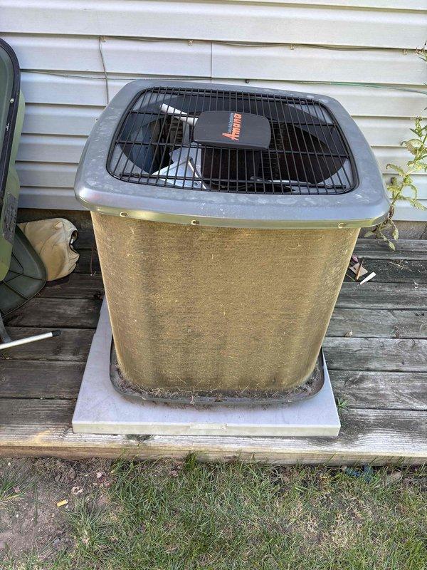 Completed comprehensive air conditioning tune-up on 5-year-old Bryant condenser unit. Upon arrival, observed significant accumulation of dirt, debris, and environmental contamination on exterior coil fins, appearing as yellowish-green and brownish discoloration that could restrict airflow and reduce system efficiency. Performed standard maintenance protocol including coil cleaning, refrigerant level verification, electrical connection inspection, and fan motor operation assessment. Additionally completed dryer vent cleaning service as requested. Unit operational and cooling properly upon service completion.