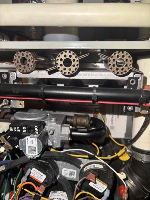 Completed comprehensive BFMA tune-up on 8-year-old furnace system during scheduled morning appointment. Performed full inspection of blower assembly, burner components, gas valve, and electrical controls; noted dust accumulation on blower wheel and housing with some staining present but within normal operational parameters. Cleaned and serviced all accessible components, verified proper operation of all safety controls including pressure switches and flame sensors, confirmed secure wiring connections throughout control board assembly, and tested system for proper ignition sequence and heating cycle performance.