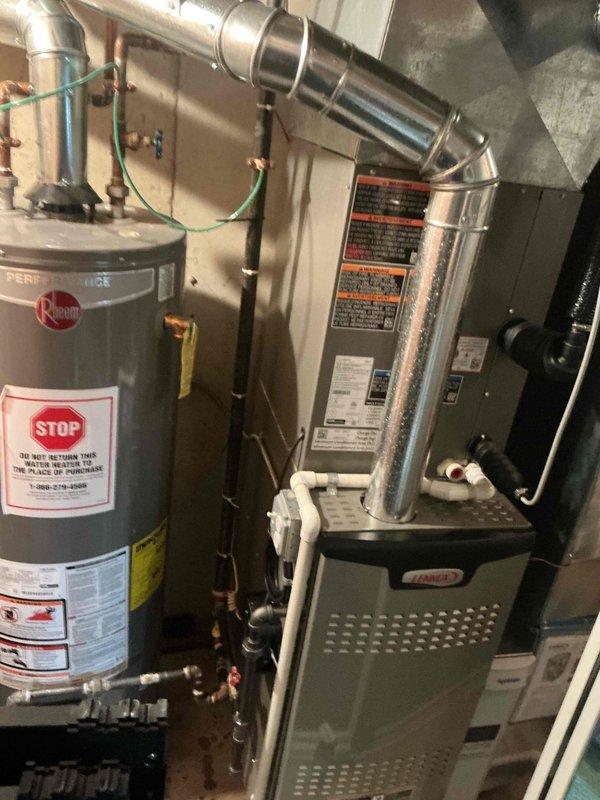 Completed comprehensive furnace tune-up maintenance on residential HVAC system as part of preventative maintenance program. Inspected furnace unit with 4+ years of service, verified all safety controls and operational parameters, and documented equipment condition including associated Rheem water heater in mechanical room. System found to be operating within normal specifications with all components functioning properly at time of service.