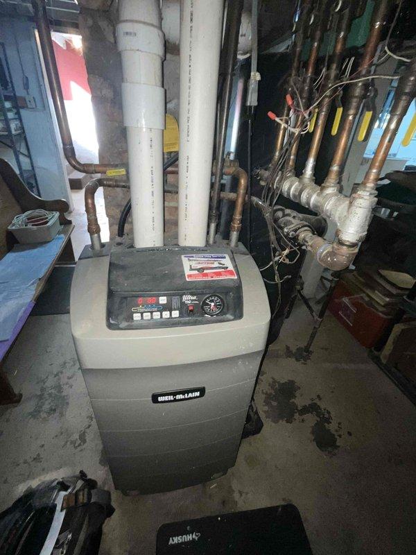 Performed comprehensive tune-up on Weil-McLain boiler system, utilizing specialized maintenance kit as required for this unit. Inspected and serviced digital control panel, verified pressure readings on system gauge (0-320 PSI range), and examined all copper piping connections and PVC venting components for proper operation. Completed standard maintenance procedures including cleaning, adjustments, and system testing to ensure optimal performance and safety of the heating system.