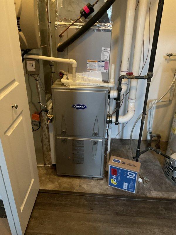 Completed comprehensive BFMA tune-up on 9+ year old Carrier furnace system in residential basement utility room. Performed standard maintenance protocol including system inspection, component testing, and replaced dirty Glasflast air filter that showed significant dust accumulation. All HVAC equipment operating within normal parameters upon completion of service.