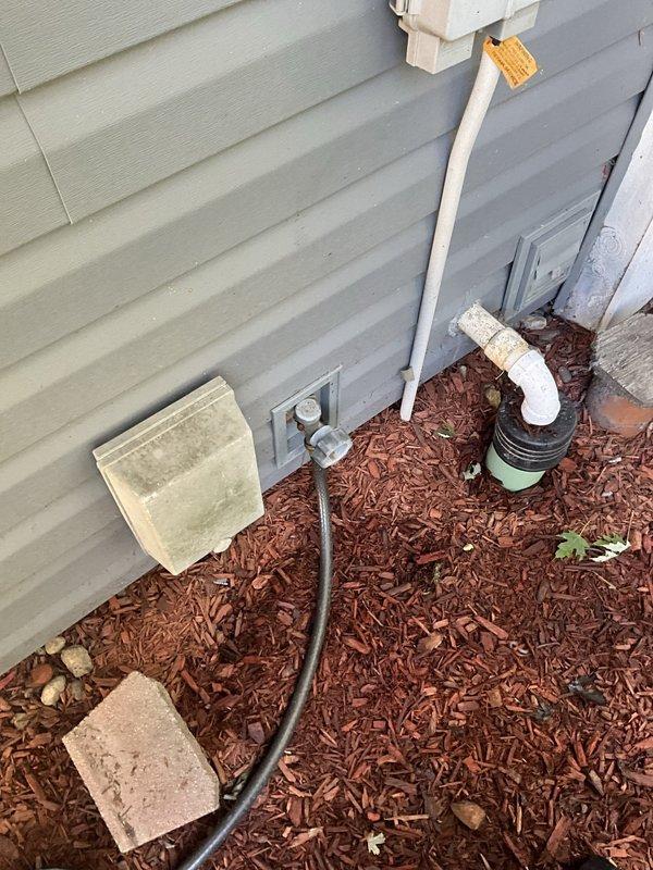 Responded to report of leaking outdoor spigot and performed inspection of exterior hose connection point. Accessed wall-mounted utility box containing PVC valve assembly and identified source of leak at spigot connection. Completed necessary repairs to eliminate water leakage and verified proper operation of outdoor water supply fixture.