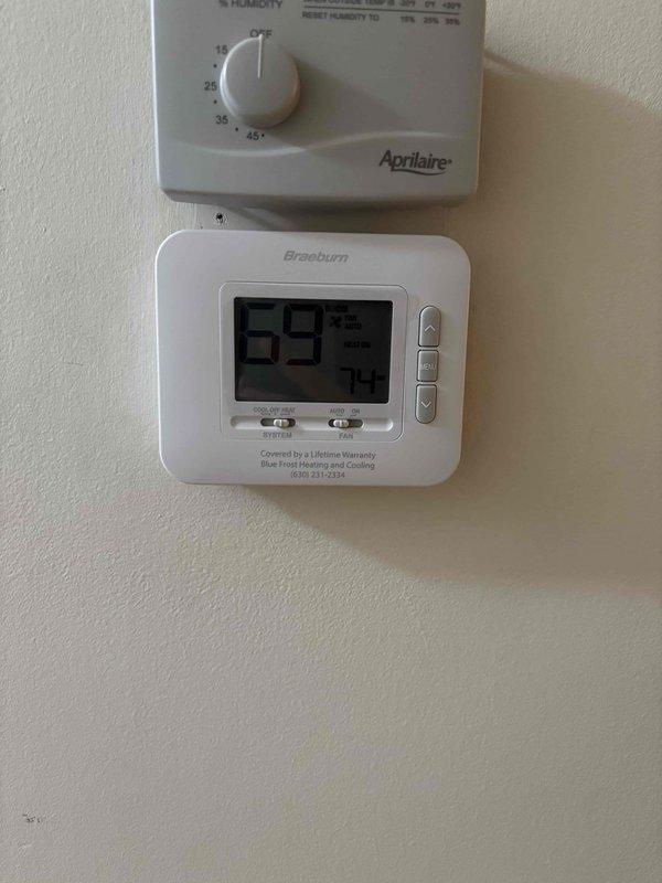 Responded to after hours service call for HVAC system inspection. Upon arrival, examined White-Rodgers control board wiring connections and verified proper termination of all low-voltage wires including thermostat connections. Inspected 16x25x1 air filter condition and confirmed proper fitment in filter rack. Documented humidistat and Braeburn digital thermostat settings, noting system displaying 69°F current temperature with 74°F setpoint. All components found operational with no immediate issues requiring repair.