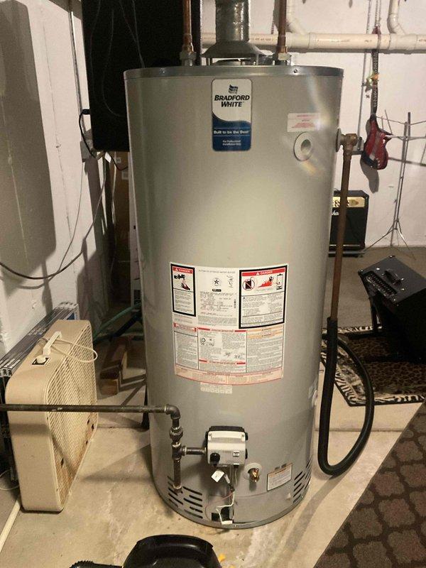 Completed comprehensive furnace tune-up and system inspection as part of BFMA maintenance agreement. Inspected and photographed 20x25x1 air filter showing clean condition with proper diagonal cross-hatch media pattern and verified correct installation in ductwork. Documented Bradford White water heater installation showing proper venting, copper piping connections, gas control valve assembly, and all safety labels intact and visible.