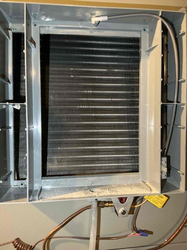 Completed comprehensive BFMA tune-up service on heating system including furnace and humidifier maintenance per recurring ESA agreement. Inspected evaporator coil assembly showing normal dust accumulation on fins, verified refrigerant line connections and copper tubing integrity throughout system. Performed standard maintenance procedures on 2-year-old equipment, checked attic-mounted ductwork and mechanical components, and confirmed all systems operating within manufacturer specifications.