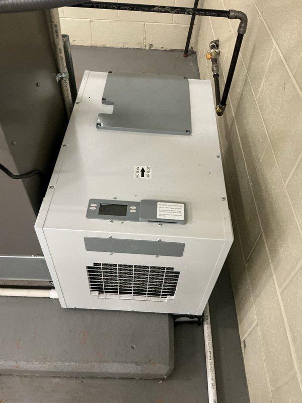 Completed installation of a new 3-ton HVAC system including EL196UH090 furnace, ML13KC1 condenser, and 130-pint dehumidifier in commercial facility. System was sized per customer specification at 3 tons of cooling capacity, which differs from the original 5-ton load calculation based on motor heat load specifications. All equipment installed in mechanical room, properly mounted and secured with gas piping, refrigerant lines, and ductwork connections completed per manufacturer specifications and code requirements.