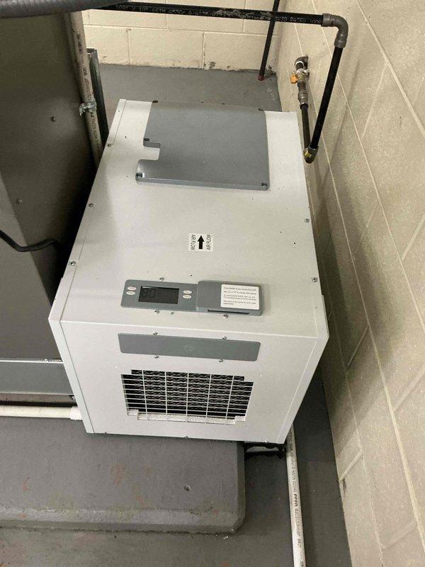 Completed installation of a new 3-ton HVAC system including EL196UH090 furnace, ML13KC1 condenser, and 130-pint dehumidifier in commercial facility. System was sized per customer specification at 3 tons of cooling capacity, which differs from the original 5-ton load calculation based on motor heat load specifications. All equipment installed in mechanical room, properly mounted and secured with gas piping, refrigerant lines, and ductwork connections completed per manufacturer specifications and code requirements.