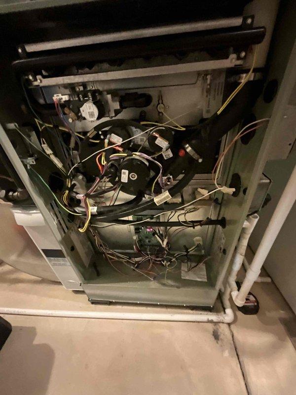 Completed comprehensive BFMA furnace tune-up on 6-year-old residential heating system. Performed full inspection of furnace components including blower motor assembly, electrical connections, wiring harness, and control board; verified all wire connections were secure and properly terminated. Inspected condensate drainage system with white PVC piping, confirmed proper routing and functionality; checked water heater integration and mechanical room ventilation system including ductwork connections and airflow pathways.