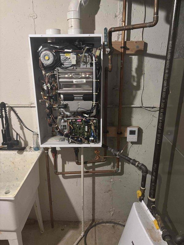 Responded to no hot water complaint on older Navien NR-240 tankless water heater that had been red-tagged by gas utility following gas leak repair. Performed comprehensive combustion analysis testing to verify safe operation and proper venting. Inspected all internal components including heat exchanger, blower assembly, circuit boards, and wiring harnesses. Verified gas supply connections, water supply piping, and exterior venting system integrity. Unit cleared for operation after successful combustion testing confirmed equipment met safety standards.
