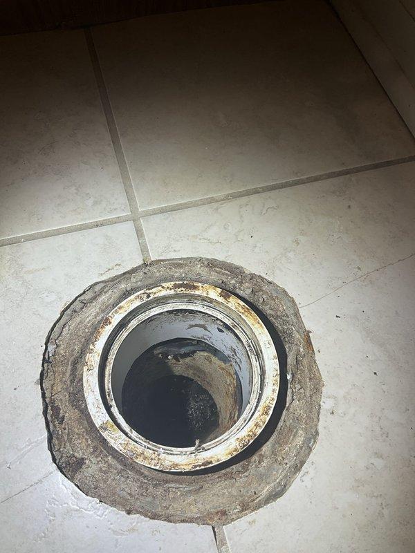 Completed installation of new toilet fixture where previous unit had been removed by homeowner. Inspected Rheem Performance water heater due to pilot light intermittently extinguishing without warning, examined gas control valve, thermocouple connections, and venting system to diagnose ignition issues. Documented existing floor drain conditions and surrounding tile deterioration in bathroom area.
