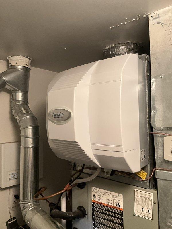 Completed annual HVAC maintenance and tune-up on 2-year-old Trane heating system with integrated Aprilaire humidifier. Performed comprehensive inspection of furnace and humidification system, including examination of evaporator pad which showed mineral deposits and discoloration indicating normal operational wear. Verified proper installation and connection of ductwork, electrical wiring, and water supply lines to humidifier unit. All system components functioning within normal parameters.