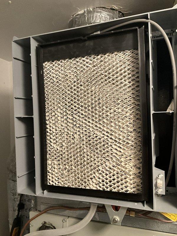 Completed annual HVAC maintenance and tune-up on 2-year-old Trane heating system with integrated Aprilaire humidifier. Performed comprehensive inspection of furnace and humidification system, including examination of evaporator pad which showed mineral deposits and discoloration indicating normal operational wear. Verified proper installation and connection of ductwork, electrical wiring, and water supply lines to humidifier unit. All system components functioning within normal parameters.