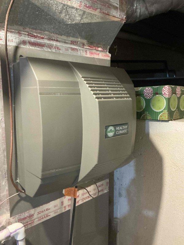Completed comprehensive BFMA tune-up on 11-year-old HVAC system including furnace maintenance, humidifier service with #35 pad replacement, and semi-annual filter change with 20x25x5 filter. Inspected Healthy Climate humidifier unit, verified proper operation, replaced humidifier pad, and checked water supply connections and drainage. Installed new pleated air filter, performed furnace safety and operational checks, and confirmed all system components functioning properly within manufacturer specifications.