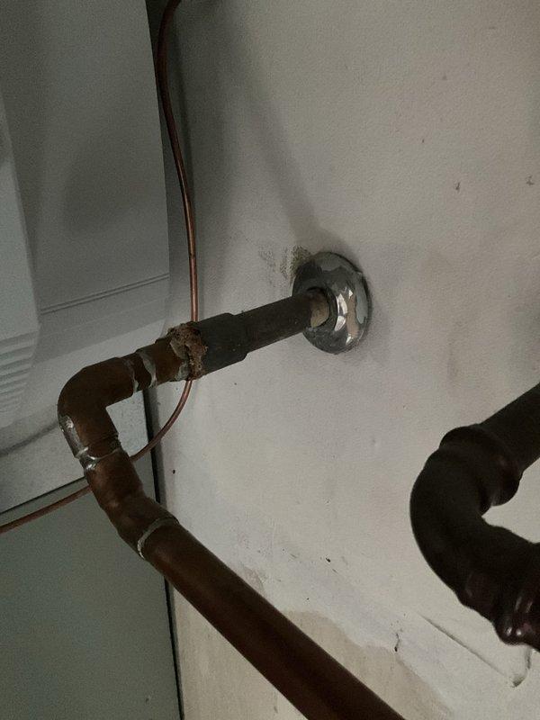 Responded to service call for loud knocking noise coming from residential tanked water heater. Upon arrival, inspected unit and identified sediment buildup in tank causing the knocking sound, commonly known as "kettling." Examined water heater components including temperature and pressure relief valve, gas control valve, and burner assembly. Noted significant corrosion on inlet/outlet piping connections at wall penetration, indicating age-related deterioration of plumbing infrastructure. Flushed water heater tank to remove accumulated sediment and mineral deposits that were causing the noise during heating cycles. Tested unit operation after service and confirmed elimination of knocking sounds. Advised customer of corroded pipe conditions and recommended monitoring for potential future replacement needs.
