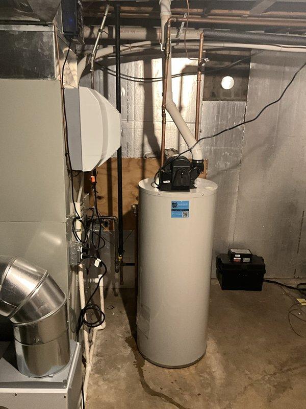 Completed residential installation of a new 40-gallon natural gas power vent Bradford White water heater in basement mechanical room. Removed existing water heater and properly disposed of old unit. Made necessary modifications to gas supply line, water supply and discharge piping, and power vent exhaust system to accommodate new equipment. Installed black gas piping with proper support and connection to unit, modified copper water supply lines with appropriate shutoff valve, and configured PVC power vent piping system for proper exhaust ventilation. Verified all connections for leaks, tested gas pressure and combustion operation, and confirmed proper venting and water flow. Unit includes 6-year tank warranty and 1-year parts and labor coverage, with all work performed to code specifications.