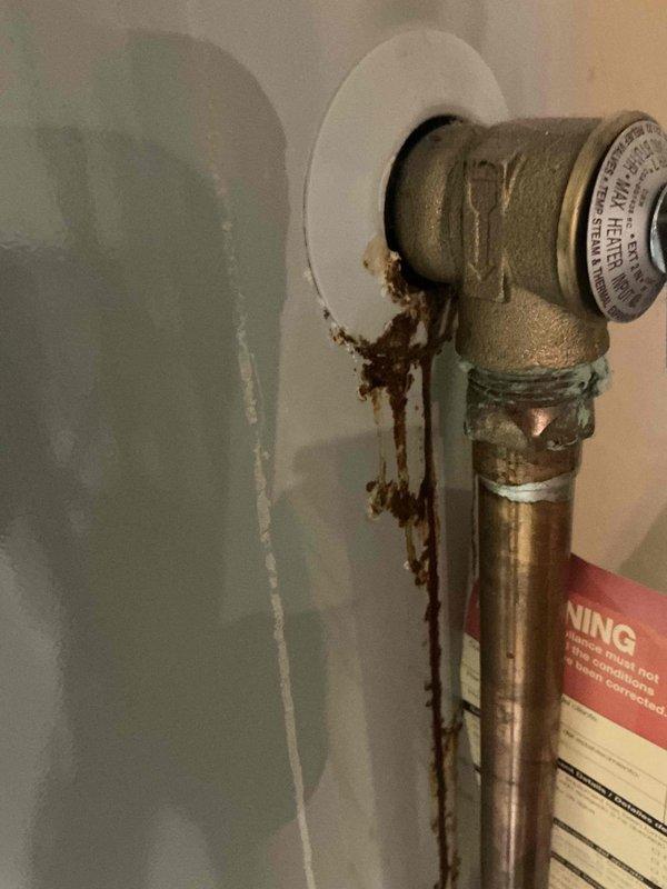 Completed comprehensive BFMA furnace tune-up on 2+ year old system, including full inspection of blower motor assembly, capacitor check, and filter replacement. Blower wheel and motor housing found in good operating condition with no visible wear or deterioration. Identified significant rust staining and evidence of water leakage around humidifier connection point at wall penetration, with mineral deposits indicating ongoing seepage from elbow joint requiring attention to prevent further damage.