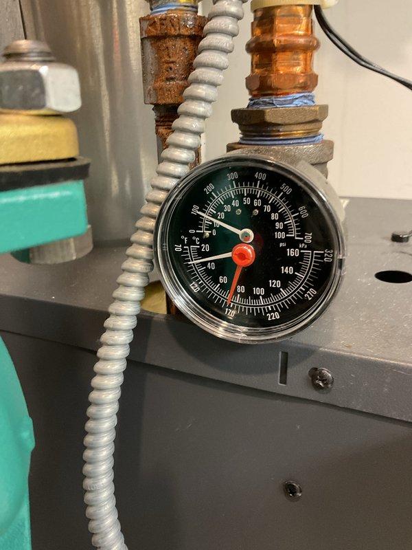 Completed comprehensive BFMA tune-up service on 2-year-old boiler system per LL1 compliance requirements. Performed full system inspection, monitored operating pressures and temperatures which registered at 188°F on digital control display, verified all gauges reading within normal parameters, and inspected copper piping connections for integrity. Documented system conditions with photos showing pressure/temperature gauges, control panel with digital readout, and overall equipment operation for service records.