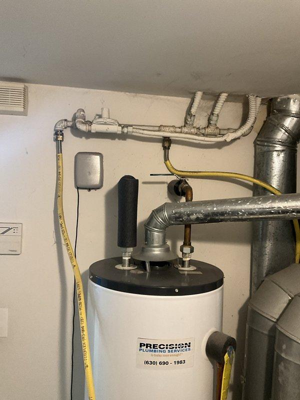 Responded to no hot water complaint at residential property. Upon arrival, evaluated existing 40-gallon tanked water heater that had failed and was no longer producing hot water. Assessed utility room conditions and existing plumbing connections including water supply lines, gas line, pressure relief valve, and venting system. Provided estimate for complete water heater replacement. Documented existing installation with photos showing water heater unit, associated plumbing connections, gas line routing, electrical components, and surrounding mechanical systems for replacement planning purposes.
