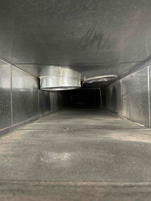 Completed comprehensive duct cleaning service for residential HVAC system. Inspection revealed significant debris accumulation, dust buildup, and rust-colored staining within the ductwork, particularly in the lower sections of the cylindrical flexible ducts and rectangular metal supply channels. Performed thorough cleaning of all accessible ductwork components, removing accumulated particulates and contamination from interior surfaces. System components showed normal operational wear consistent with extended service life. All ductwork connections and metallic collars were inspected and verified structurally sound following cleaning procedures.