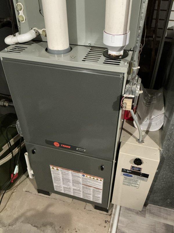 Responded to no-heat call where technician identified a cracked heat exchanger requiring system replacement. Conducted on-site evaluation of existing Trane furnace installation with integrated humidifier system in residential basement location. Documented current equipment configuration including PVC venting, humidification components, and associated ductwork to prepare comprehensive replacement proposal for homeowner review.