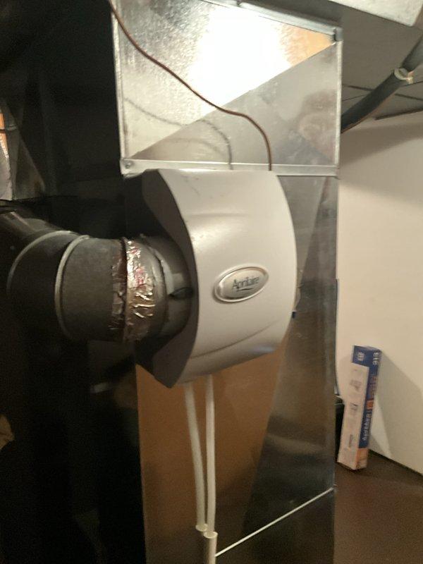 Performed a routine tune-up on a two-year-old gas furnace, including filter replacement and humidifier maintenance, with no issues or abnormal symptoms found. Inspected the whole-home Aprilaire humidifier and its duct and water line connections, finding no leaks, rust, or damage. Verified normal thermostat operation, with indoor conditions at 77°F and 53% humidity.