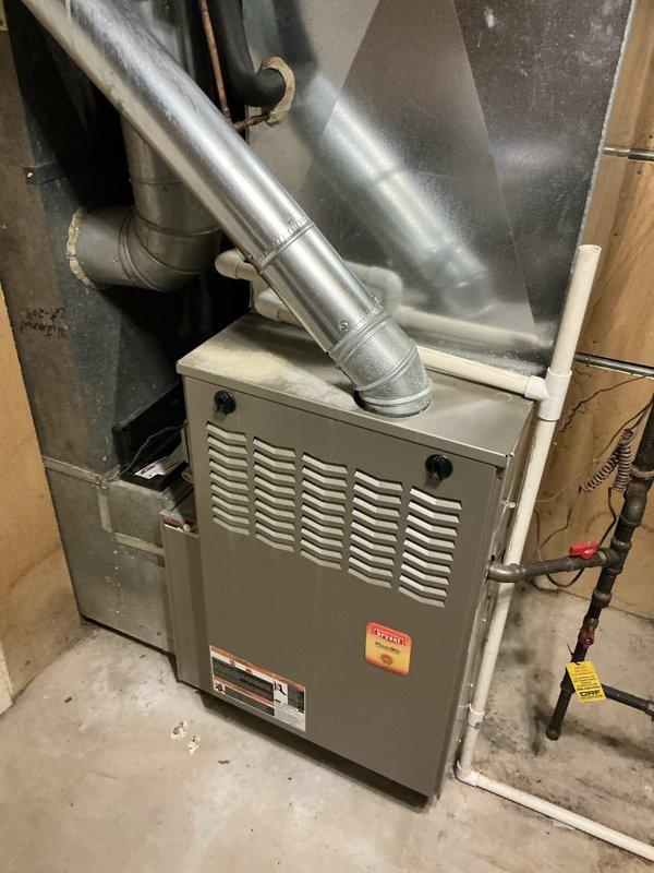 Performed a seasonal heating maintenance tune-up on a 12-year-old Bryant gas furnace, inspecting the unit, venting, gas piping, and condensate drain components for proper operation. No trouble found; the system was operating normally with no repairs required.