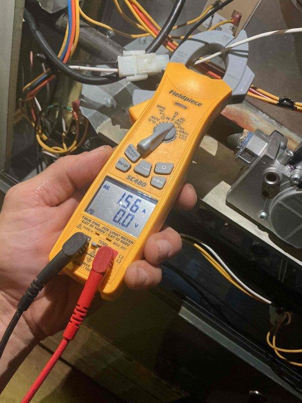 Performed a complete furnace tune-up on a 7-year-old unit, including inspection of the control compartment, gas valve, and wiring connections, and verified blower motor amperage draw with a calibrated clamp meter (15.6 amps measured). Inspected the squirrel-cage blower wheel and housing, which showed dust and grime accumulation. Unit operation was checked as part of the recurring maintenance service.