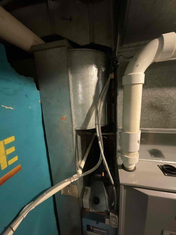 Performed an on-site evaluation of the existing gas furnace to provide a replacement estimate, inspecting the cabinet, PVC venting, galvanized plenum and ductwork, condensate drain fittings, and control/electrical components. Documented equipment condition, noting light dust and surface discoloration with no visible frost, ice, or rust, and photographed the installation for sizing and replacement scoping.