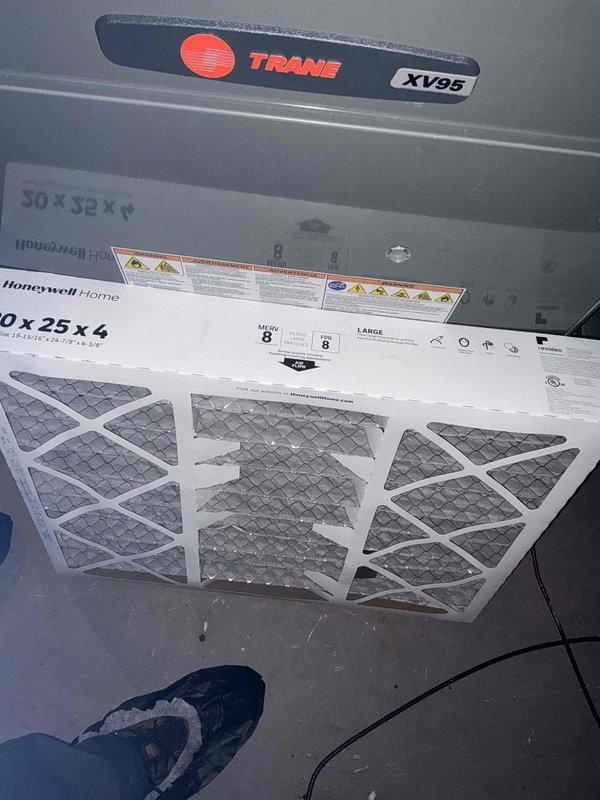 Performed a seasonal cooling maintenance tune-up on a 4-year-old Trane system, including inspection of the air handler/furnace cabinet and evaporator airflow components. Replaced the 20x25x4 return air filter with a new Honeywell MERV 8 pleated filter to restore proper airflow and system efficiency, and cleaned the louvered grille and vent surfaces to remove dust buildup. System was left operating normally upon completion.