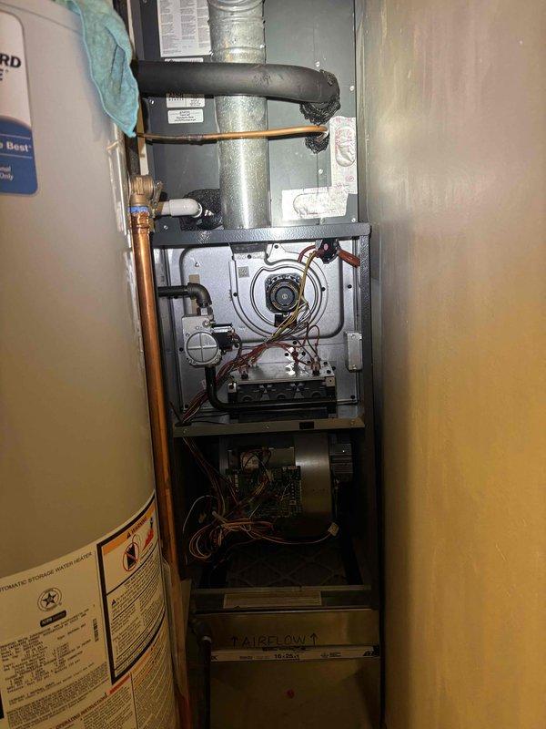 Performed a full tune-up on the upright gas furnace and storage water heater, including inspection of the blower and inducer motors, gas valve and piping, burner assembly, control board wiring, and the 16x25 return filter section. Inspected the water heater pilot and thermocouple assembly and found corrosion on the burner cap along with deteriorated, crumbling combustion chamber insulation, which should be addressed to maintain safe and efficient operation. No frost, rust-through, or breakage was observed on the furnace cabinet or refrigerant and duct connections.