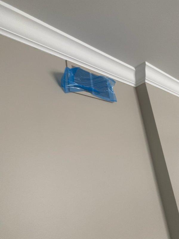 Performed a routine tune-up on a 1-year-old split system, inspecting the air handler cabinet, electrical connections, and air filter, and servicing the unit to confirm normal operation with no deficiencies found. Walked the home to identify and remove leftover protective blue plastic and tape covering supply registers from a recent duct cleaning, restoring full airflow at the affected vents. Advised that the covering is a standard part of the duct cleaning process and that the ducts were cleaned.
