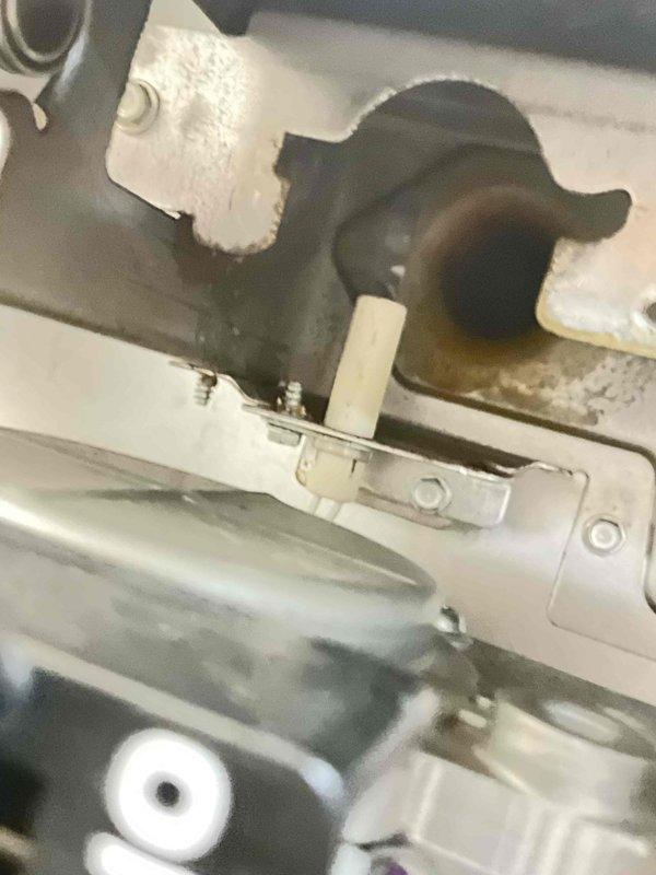Performed a complete tune-up on an 8-year-old gas furnace, inspecting the burner assembly, gas valve, inducer motor, pressure switches, PVC vent connections, and wiring harness for proper operation. Inspected the igniter and flame sensor assembly, noting soot staining and light rust residue at the burner opening, and verified secure mounting hardware. Equipment was found operational with no frost or heavy corrosion present, and the unit was enrolled in a recurring furnace maintenance plan.