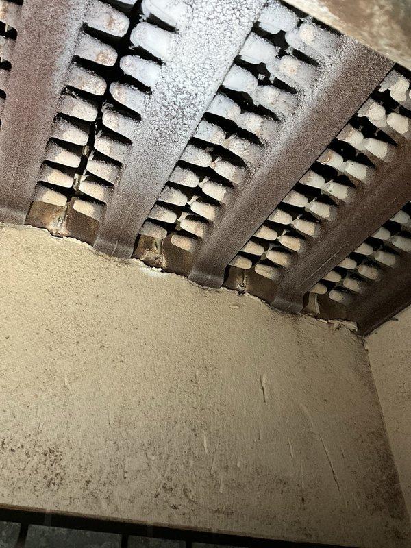 Diagnosed a failed gas valve and quoted replacement; part to be staged for installation. Removed the burner and pilot assembly and wire-brushed it to clear oxidation and heat-related corrosion for inspection. Also observed heavy frost and ice buildup on the evaporator coil, indicating a possible airflow or refrigerant-related issue that should be addressed.