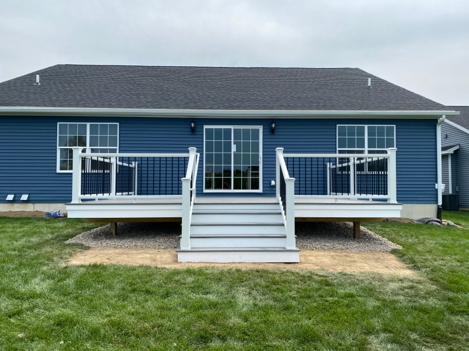 Just finished up this lovely 14x20 Trex deck. This deck features Island Mist Decking, white Trex Transcend rails with black spindles, and lighted Trex post caps. All finished up in Fowlerville. 