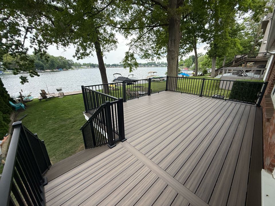 Brighton, MI - Day 2 at work after two days of terrible rain we were able to wrap up this 280 sq ft custom Trex deck that is sure to be the envy of all the neighbors on the lake. This deck features Trex Enhanced Naturals Rocky Harbor decking, Costal Bluff picture frame, black Trex Signature Railings and white Azek fascia. Brighton, MI - Day 2 at work after two days of terrible rain we were able to wrap up this 280 sq ft custom Trex deck that is sure to be the envy of all the neighbors on the lake. This deck features Trex Enhanced Naturals Rocky Harbor decking, Costal Bluff picture frame, black Trex Signature Railings and white Azek fascia.