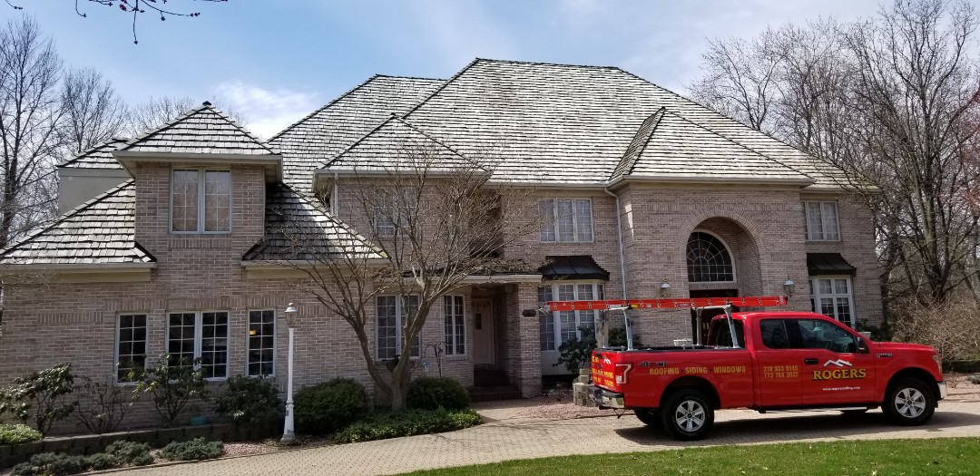 Schererville, IN - Installing new seamless aluminum gutters and downspouts with gutter protection. Schererville, IN - Installing new seamless aluminum gutters and downspouts with gutter protection.