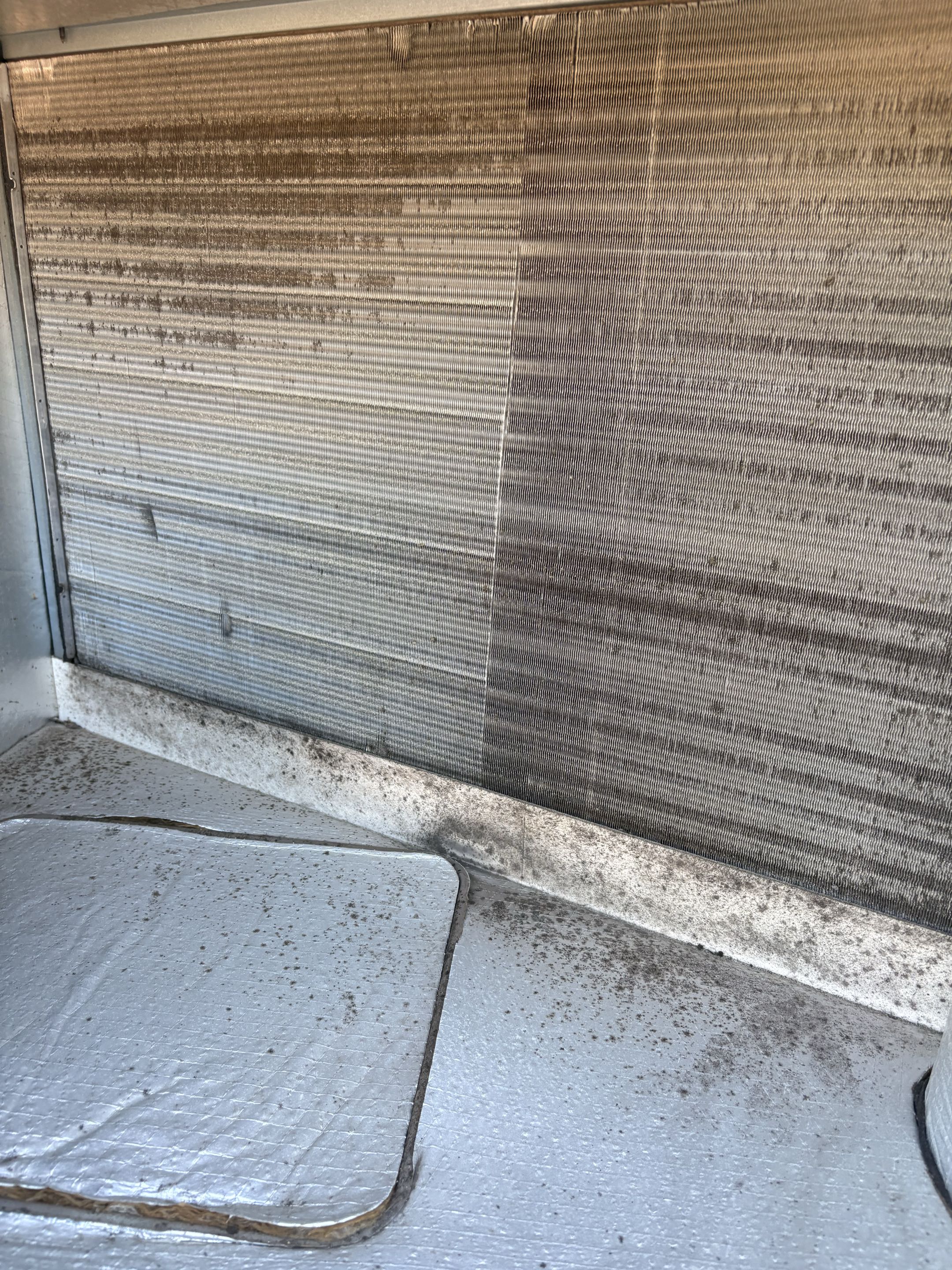 Residential service call. York package unit experiencing cooling issues. Perform check service maintenance, electrical components, condenser, evaporator coils debris, and dirty filter. Thermostat loose off base plate. 