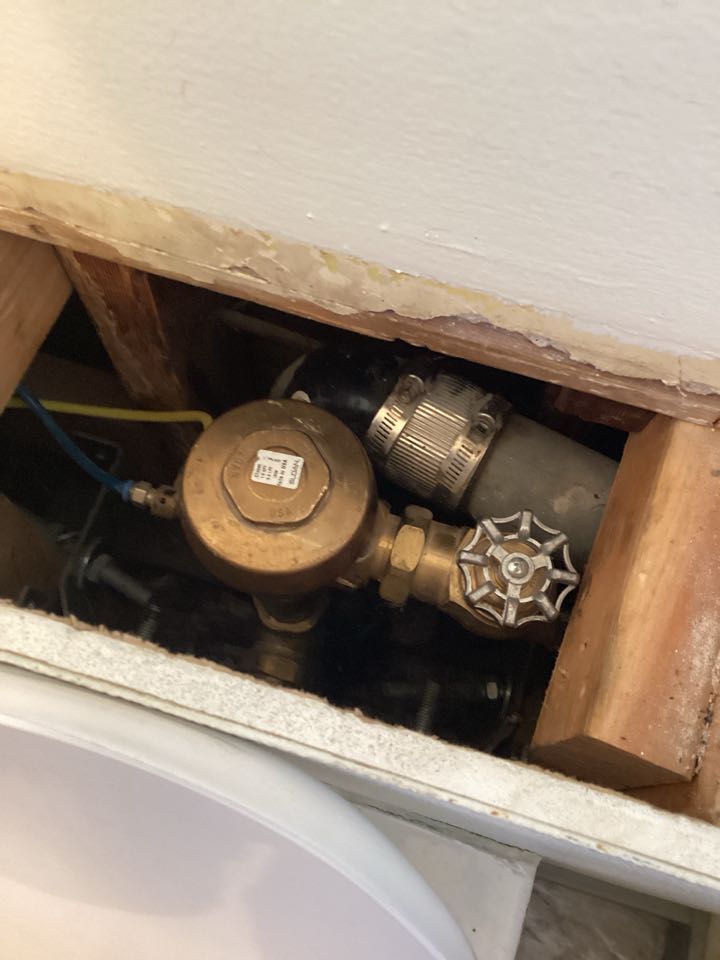 Install diaphragm in back half restroom wall mount toilet for a Sloan valve in Anaheim, California for a single family 2 1/2 bathroom house