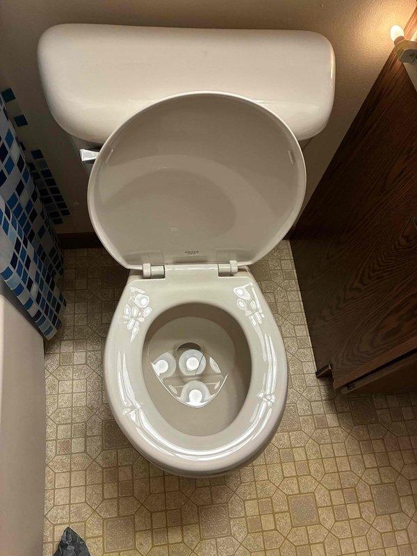 Provided customer with estimate for installation of new comfort height elongated toilet to replace current low-profile unit. Examined existing plumbing connections including chrome shutoff valve and metal supply line, which appear to be in good working condition. Discussed color options and comfort benefits of taller toilet model with customer.