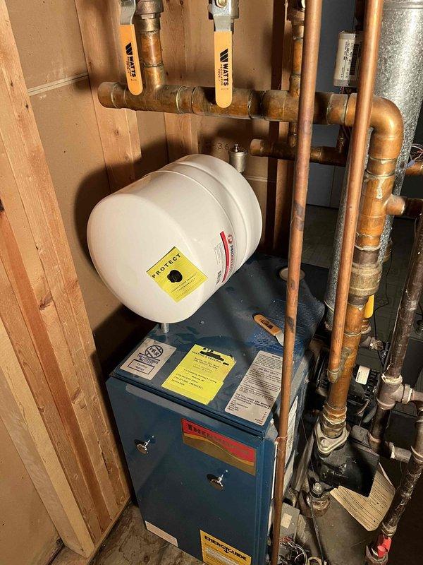 Responded to service call for boiler leakage. Diagnosed waterlogged expansion tank causing relief valve to leak. Offered repair solution to replace both the expansion tank and relief valve to resolve the issue.