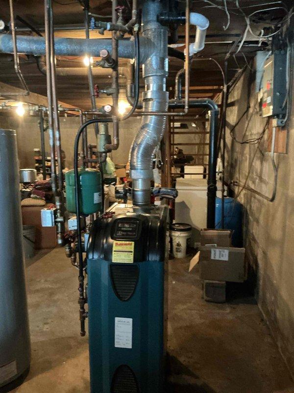Performed annual preventive maintenance on approximately 7-year-old boiler system. Inspection revealed significant oxidation on copper heat exchanger components. Documented condition of installation including expansion tank, venting, and associated plumbing infrastructure for service records.
