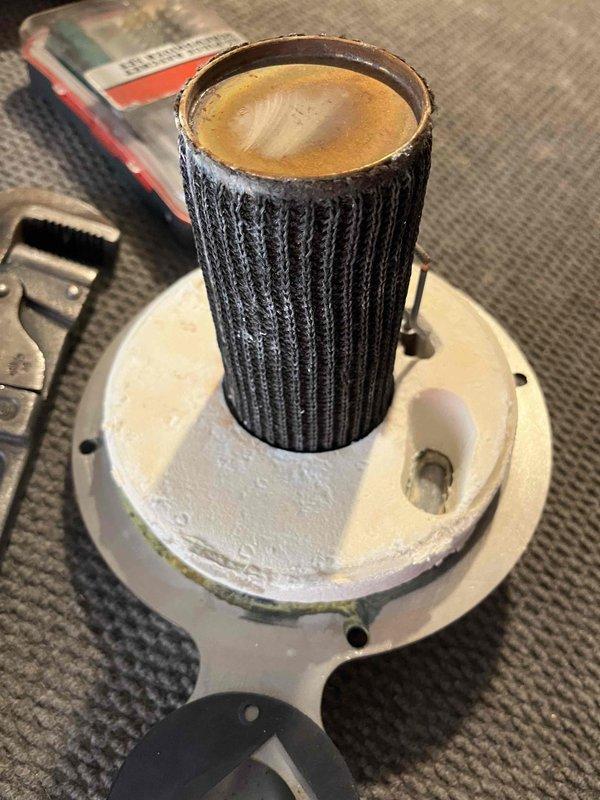 Replaced igniter gasket and bathroom zone pump while performing comprehensive heat exchanger cleaning. Addressed additional issues including cleaning plugged backflow and feed valve screens, freeing up check valve, and correcting improperly pitched exhaust pipe. System still experiencing intermittent ignition problems and fan operation irregularities; recommended follow-up service visit for further diagnostics.