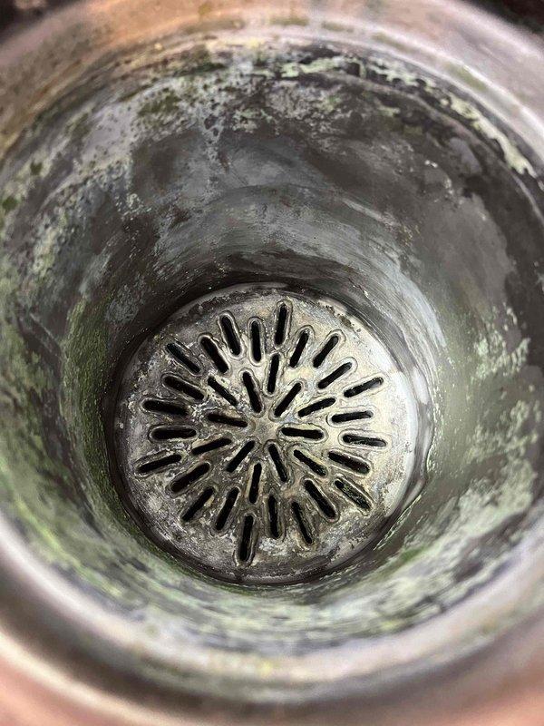 Replaced igniter gasket and bathroom zone pump while performing comprehensive heat exchanger cleaning. Addressed additional issues including cleaning plugged backflow and feed valve screens, freeing up check valve, and correcting improperly pitched exhaust pipe. System still experiencing intermittent ignition problems and fan operation irregularities; recommended follow-up service visit for further diagnostics.