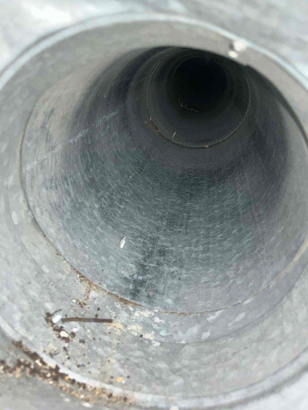 Inspected ductwork system and identified accumulation of dust and minor deposits along the interior walls and bottom surfaces of cylindrical metal ducts. Scheduled complete duct cleaning service for customer in the coming two weeks to remove these contaminants and improve system airflow.