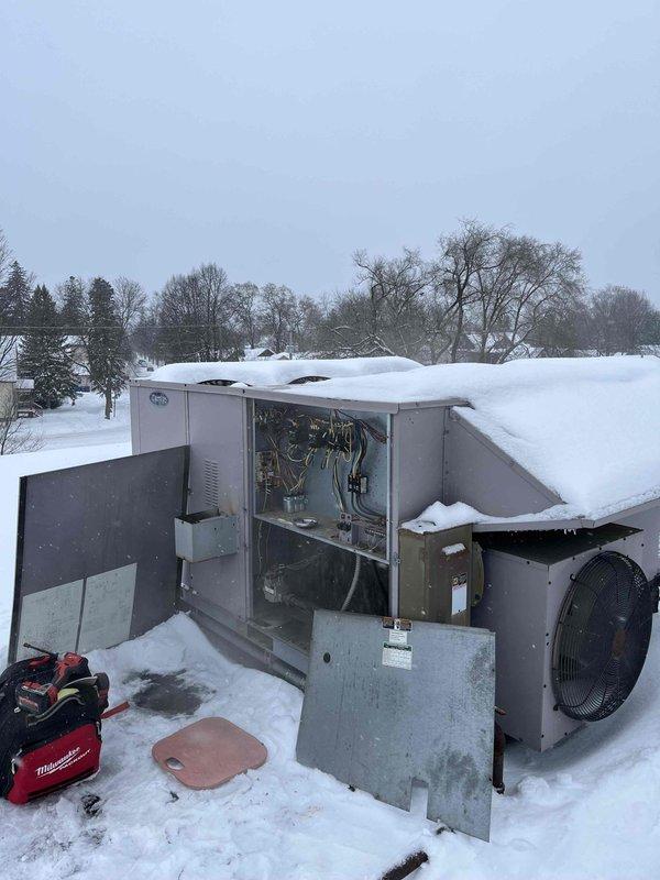 Responded to no-heat call for rooftop unit experiencing intermittent shutdown code and sleep mode issues. Diagnostic inspection revealed unit was experiencing temperature sensor malfunction, causing system to enter safety shutdown when temperatures read incorrectly. Cleaned snow accumulation from critical components and recalibrated thermostat which was displaying inaccurate reading (35.8°F). Unit restored to normal operation with proper ignition sequence.