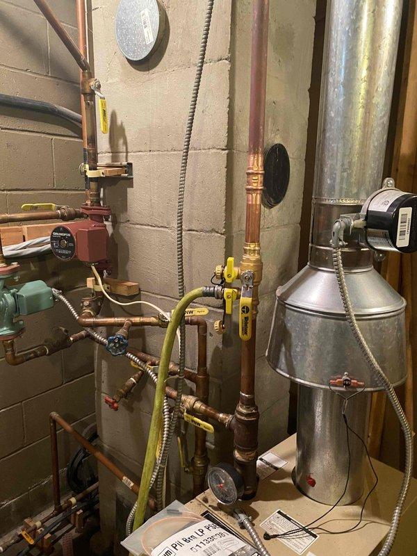Completed comprehensive boiler system overhaul including drain and purge with cleaner flush. Replaced customer-supplied circulating pumps and control module along with installation of new expansion tank with shut-off valve, three boiler drain valves, pilot assembly, relief valve, auto feed backflow preventer, and upgraded air separation. System restored to full operational condition with all components properly installed and tested.