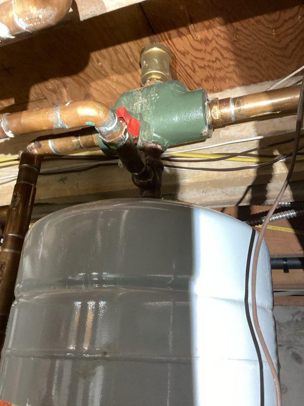 Responded to service call regarding loud noises and erratic pressure readings from boiler system. Inspection revealed excessive corrosion affecting the heat exchanger and restricted water flow throughout the system. Documented conditions with photos of the plumbing network, expansion tank, and valve assembly for follow-up repair and replacement options to be provided to customer.